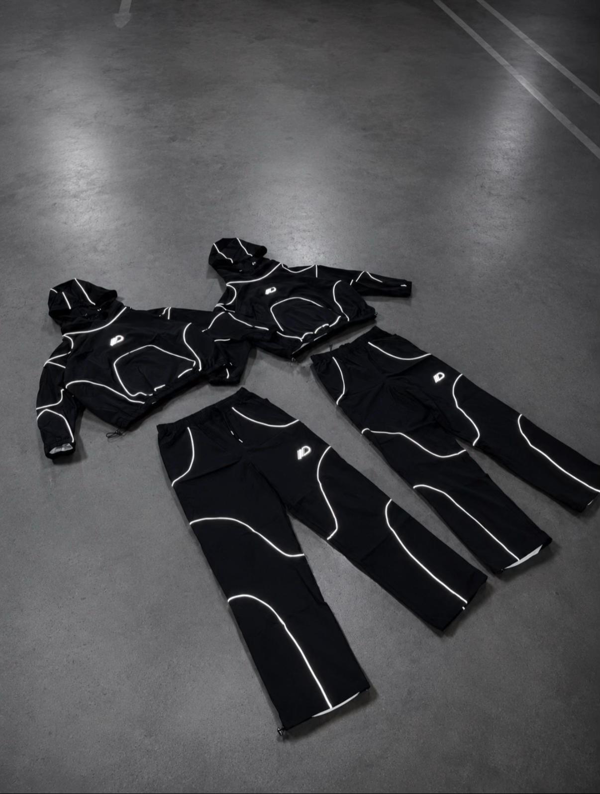 Reflective black tracksuit set laid flat