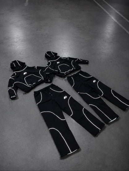 Reflective black tracksuit set laid flat