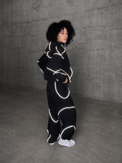 Model wearing the reflective black tracksuit set