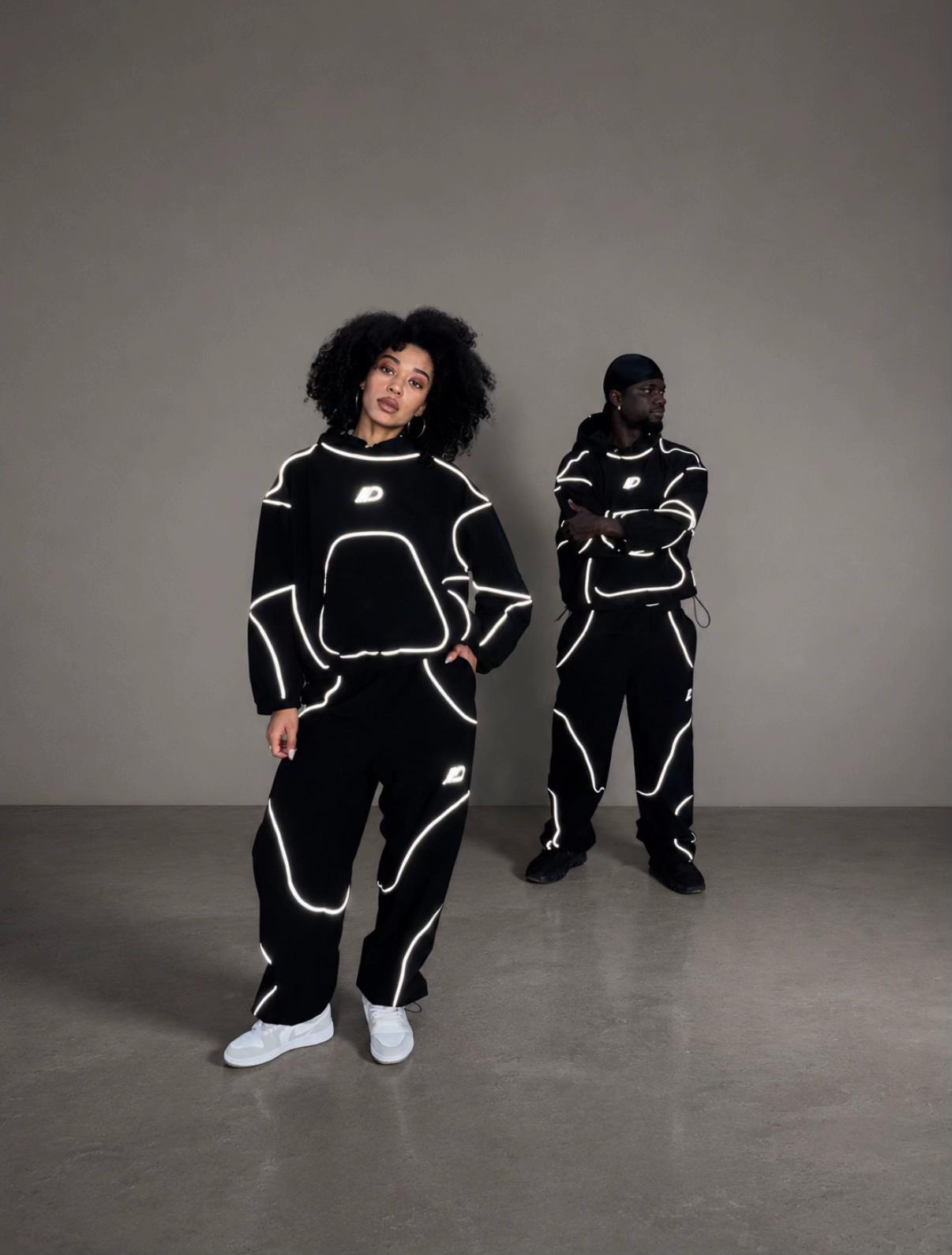 Women and men styling the reflective tracksuit set
