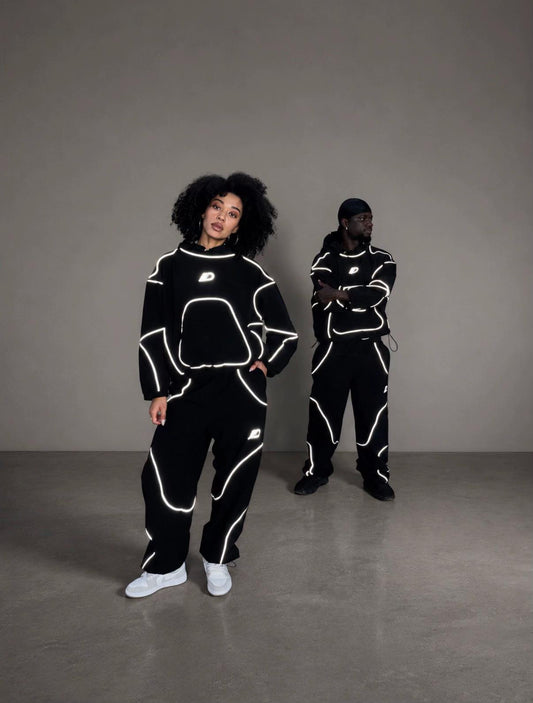 Women and men styling the reflective tracksuit set